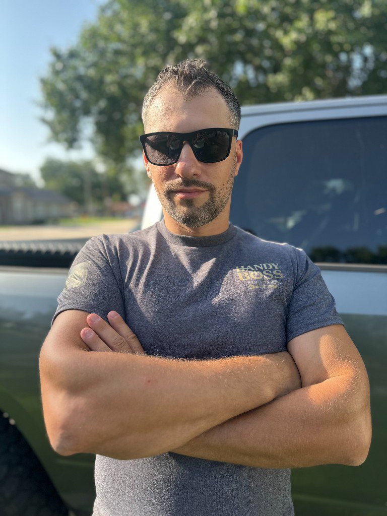 Owner of Handy Boss Services outside the company truck in Wylie, TX
